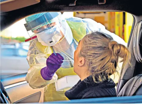  ??  ?? A nurse tests a member of the public for Covid-19 at a drive-through clinic in Antrim, Northern Ireland. Below, Larry Summers predicted the catastroph­ic impact of a pandemic in 2016