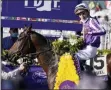  ?? MICHAEL CONROY - THE ASSOCIATED PRESS ?? Pierre-Charles Boudot, celebrates after riding Order of Australia to win the Breeders’ Cup Mile horse race at Keeneland Race Course, in Lexington, Ky., Saturday, Nov. 7, 2020.