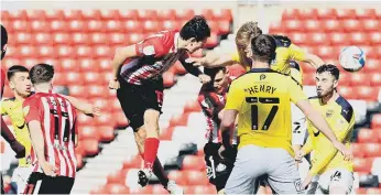  ??  ?? Luke O’Nien climbs to get a header in during Good Friday’s 3-1 win over Oxford United. Picture by Frank Reid