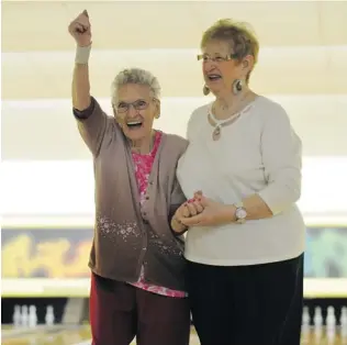  ?? ARLEN REDEKOP/ PNG ?? Grace Browning, 104, celebrates a spare with her daughter, Bev Norman, at Scottsdale Lanes in Surrey. Browning has been bowling for at least 60 years.