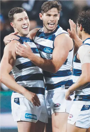  ?? Picture: MICHAEL DODGE ?? FINALS BOUND: Sam Menegola, Tom Hawkins and Steven Motlop celebrate in Saturday’s Round 23 win over Greater Western Sydney at Simonds Stadium.