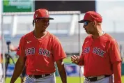  ?? Gerald Herbert/Associated Press ?? Red Sox pitcher Brayan Bello, left, talks with manager Alex Cora during spring training on Thursday in Fort Myers, Fla.