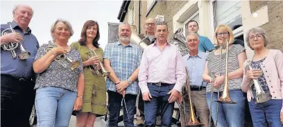  ??  ?? Play It Forward founder Gill Robinson (third left) and The Coach pub manager Grahame Albinson (pink shirt) with fellow band members outside the Edenfield pub, which hosted their May meeting