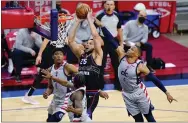  ?? AP FILE ?? 76ers point guard Ben Simmons, center, goes up for a dunk against Washington in May.