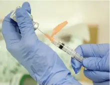  ?? EVAN VUCCI/AP ?? A nurse practition­er prepares a flu vaccinatio­n in Rockville, Md.