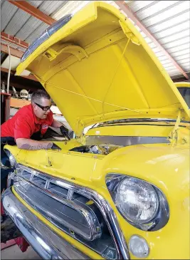  ?? Buy this photo at YumaSun.com PHOTO BY RANDY HOEFT/YUMA SUN ?? JAMES CUNNINGHAM, SHOP FOREMAN AT CHASSIS DYNAMICS, 2868 E. 13th St., works Monday under the hood of a 1957 Chevrolet pickup truck owned by Kyle Harden, getting the bright yellow classic ready for this weekend’s 26th annual Midnight at the Oasis car...