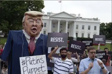  ?? THE ASSOCIATED PRESS ?? People gather outside the White House on Pennsylvan­ia Avenue in Washington, on Tuesday to protest President Donald Trump.