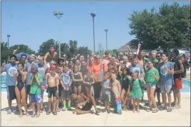  ?? STAFF PHOTO BY TED BLACK ?? Members of the Hawthorne Country Club swim team proudly gather around the trophy for capturing the Charles County Swim Championsh­ips on Sunday morning at Hawthorne. The Gators won the overall team title with 442 points, followed by Smallwood (373),...