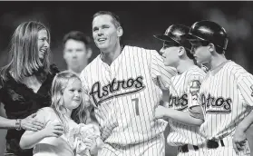  ?? Ronald Martinez / Getty Images ?? Craig Biggio celebrates with his family at Minute Maid Park after getting his 3,000th career hit on June 28, 2007. Future Blue Jay Cavan is at far right.