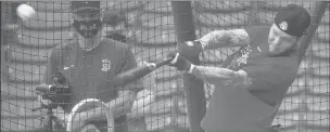  ?? MICHAEL DWYER/AP ?? The Red Sox’s Alex Verdugo swings as manager Ron Roenicke, left, looks on during practice Saturday at Fenway Park in Boston.