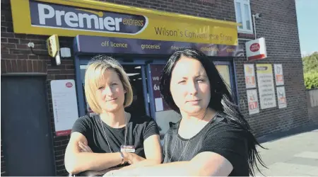  ??  ?? Natalie Cowell and Kimberley Huitson were threatened by a masked raider in their Sunderland store. Below, the pair behind the smashed screen.