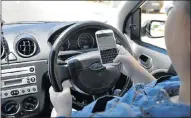  ??  ?? Cellphones can distract motorists and lead to road accidents.