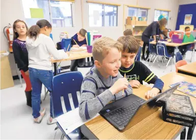  ?? ROB OSTERMAIER/STAFF ?? Cameron James, 9, and Myles Raines, 9, work on a laptop in a gifted class at Yates Elementary on Thursday. Newport News Schools are planning to add two new gifted programs for third- through fifth-graders, one for career/tech and one for visual arts/theater.