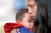  ?? — AP ?? A file picture showing a mother holding her son after he arrived at the El Paso Internatio­nal Airport in El Paso, Texas. The two had been separated for over six weeks after entering the country.