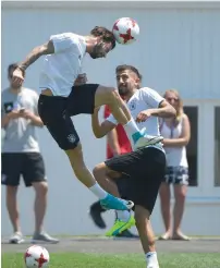  ?? AFP ?? Germany’s Marvin Plattenhar­t (left) and Kerem Demirbay vie for the ball during a training session. —