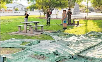  ?? ?? Cadets and recruits try out their tent-building teamwork.