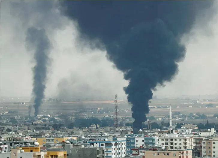  ?? (Reuters/Murad Sezer) ?? SMOKE RISES over the Syrian town of Ras al Ain, as seen from the Turkish border town of Ceylanpina­r, Turkey on Wednesday.