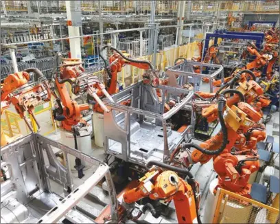  ?? PROVIDED TO CHINA DAILY ?? Robot arms are used to weld parts at an auto plant in Qingdao, East China’s Shandong province. Workers are being replaced by machines in many factories around China as labor costs have risen.