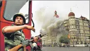  ?? AP FILE ?? A soldier takes cover as a gun battle with terrorists rages at the Taj ■
Mahal hotel, Mumbai, on November 29, 2008.