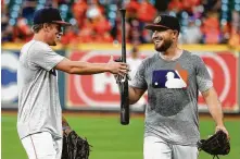  ?? Karen Warren / Staff photograph­er ?? The Astros might be mulling whether to keep speedster Myles Straw, left, or No. 3 catcher Max Stassi on their ALDS roster.