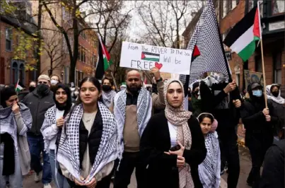  ?? Ryan Collerd/AFP via Getty Images ?? Protesters march through the streets of Philadelph­ia in support of Palestinia­ns and in protest of President Joe Biden’s visit to the city on Dec. 11.