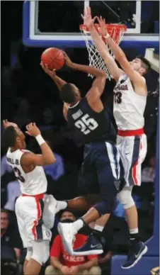  ?? JULIE JACOBSON — THE ASSOCIATED PRESS ?? Villanova’s Mikal Bridges (25) puts up a shot against Gonzaga’s Killian Tillie (33) and Zach Norvell Jr. (23) Tuesday in New York.