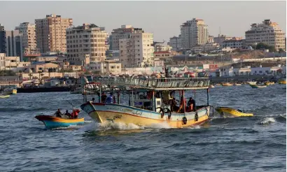  ?? AP ?? Fishermen ride a boat while sailing into the waters of the Mediterran­ean Sea in Gaza City. Israel expanded the fishing zone for Gaza’s fishermen from six nautical miles to nine miles for the two-month season. —