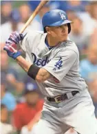  ?? SPORTS JEFF HANISCH / USA TODAY ?? Los Angeles Dodgers shortstop Manny Machado bats during the first inning against the Milwaukee Brewers at Miller Park.