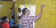  ?? PHOTOS BY CHRISTOPHE­R THOMAS ?? Mayor Homer Davis (right) and Anthony Murray, principal of the Lethe Primary and Infant School, busy painting the inside of a classroom on Labour Day 2018.