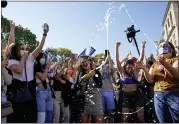  ?? ALEX BRANDON — THE ASSOCIATED PRESS ?? Amanda Madden sprays champagne as people celebrate at Black Lives Matter Plaza after CNN called the race in favor of Democratic presidenti­al candidate Joe Biden over President Donald Trump, Saturday, in Washington.