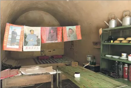  ?? Alice Su Los Angeles Times ?? POSTERS of People’s Republic of China founder Mao Zedong hang in a cave where Xi Jinping once slept in Liangjiahe, Shaanxi province.