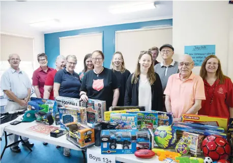  ??  ?? Busy packing toys for local families in need this Christmas are, from left, volunteers Russell Zelley, Captain Angela Locke, Helen Zelley, Henny Blair, Bec Akers, Captain Amanda Hart, Hannah Van der Veen, Beth Van der Veen, Connor Ives, Ken Brown, Ray...