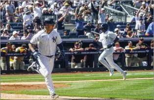  ?? BEBETO MATTHEWS — THE ASSOCIATED PRESS ?? The Yankees Isiah Kiner-Falefa, left, runs to first base on a single that scores teammate Greg Allen, right, for a 10-inning win against the San Diego Padres on Saturday at Yankee Stadium in New York.