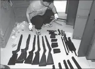  ?? PROVIDED TO CHINA DAILY ?? A police officer checks gun parts that were seized during an operation in Liuzhou, Guangxi Zhuang autonomous region.