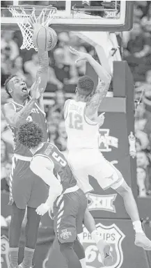  ?? Shane Keyser / Kansas City Star/TNS ?? Iowa State’s Cameron Lard, left, and Lindell Wigginton, center, attempt to intercept a pass from Texas guard Kerwin Roach, who would be injured by an elbow from Wigginton in the game.