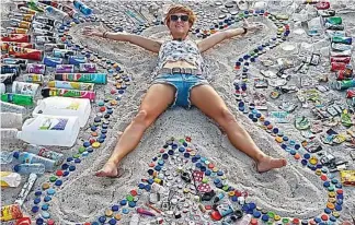  ??  ?? Surrounded by rubbish: Sian organises a weekly clean up of island beaches