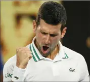  ?? ANDY BROWNBILL — THE ASSOCIATED PRESS ?? Serbia’s Novak Djokovic celebrates after defeating Russia’s Aslan Karatsev in their semifinal match at the Australian Open in Melbourne, Australia on Thursday.