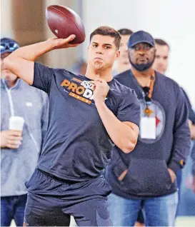  ?? [PHOTO BY CHRIS LANDSBERGE­R, THE OKLAHOMAN] ?? Pittsburgh Steelers head coach Mike Tomlin, right, watches, Oklahoma State quarterbac­k Mason Rudolph throw during the Cowboys’ Pro Day last month. The Steelers drafted Rudolph and his star wideout, James Washington, on Friday.