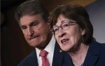  ?? DREW ANGERER, GETTY IMAGES ?? Sen. Joe Manchin, left, and Sen. Susan Collins speak after the Senate passed a vote for a continuing resolution to fund the federal government.