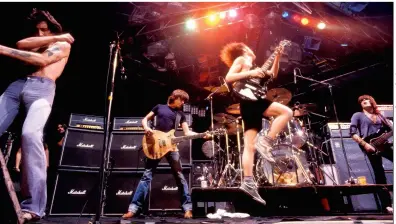  ??  ?? above Malcolm takes up his familiar position, stage right of the drum kit as the band break America, 1979