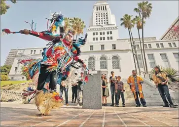  ?? Al Seib Los Angeles Times ?? KENNETH THOMAS SHIRLEY, a Navajo Nation champion dancer, performs at L.A. City Hall in 2019. Councilman Mitch O’Farrell says the city must do better in “building a better future for Native communitie­s.”