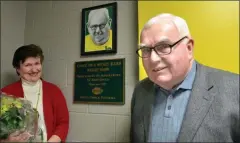  ?? MEDIANEWS GROUP FILE PHOTO ?? Lansdale Catholic football head coach Jim Algeo and his wife Mickey stand near an honorary plaque and portrait during a ceremony held Sunday, Feb. 26, 2012dedica­ting the school’s weight room to the two who, parents and students say, gave so much of their time and service to the school.