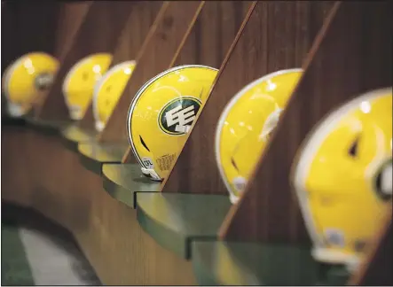  ?? DAVID BLOOM ?? Helmets line the Eskimos locker room at Commonweal­th Stadium Jan. 3 as team general manager and VP of football operations Brock Sunderland spoke to the media about changes in coaching and football operations during a news conference.