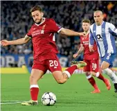  ?? — AFP ?? Liverpool’s Adam Lallana (left) in action against FC Porto at Anfield on Tuesday.
