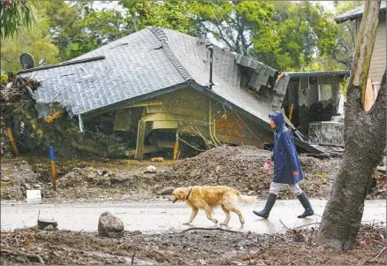  ?? Photograph­s by Robert Gauthier Los Angeles Times ?? BURN AREAS in Montecito, where a mudslide in January killed at least 21 people, are still susceptibl­e to debris flows during heavy rains. Only 1 in 10 residents heeded evacuation orders. Above, a pedestrian in March passes a home that was destroyed by the slide.