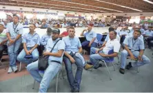  ?? JUAN CARLOS HERNANDEZ, AP ?? GM workers listen Thursday during a meeting with government officials at the company’s plant in Valencia, Venezuela.