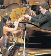  ?? Allen J. Schaben Los Angeles Times ?? YUJA WANG and L.A. Philharmon­ic conductor Gustavo Dudamel bask in post-Bartók adulation.