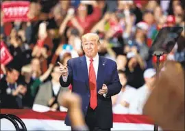  ?? Scott Olson Getty Images ?? “BY THE WAY, it doesn’t really feel like we’re being impeached,” President Trump said upon taking the stage in Battle Creek, Mich., on Wednesday night.