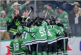  ?? GARETH PATTERSON — THE ASSOCIATED PRESS ?? The Stars celebrate Joe Pavelski’s overtime goal against the Golden Knights in Game 4of the Western Conference finals on Thursday in Dallas.