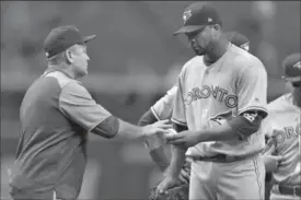  ?? CHRIS O’MEARA, THE ASSOCIATED PRESS ?? Toronto Blue Jays starter Francisco Liriano, right, hands the ball to manager John Gibbons as he is taken out of the game against the Tampa Bay Rays in the first inning Friday night in St. Petersburg, Fla. Liriano lasted one-third of an inning,...